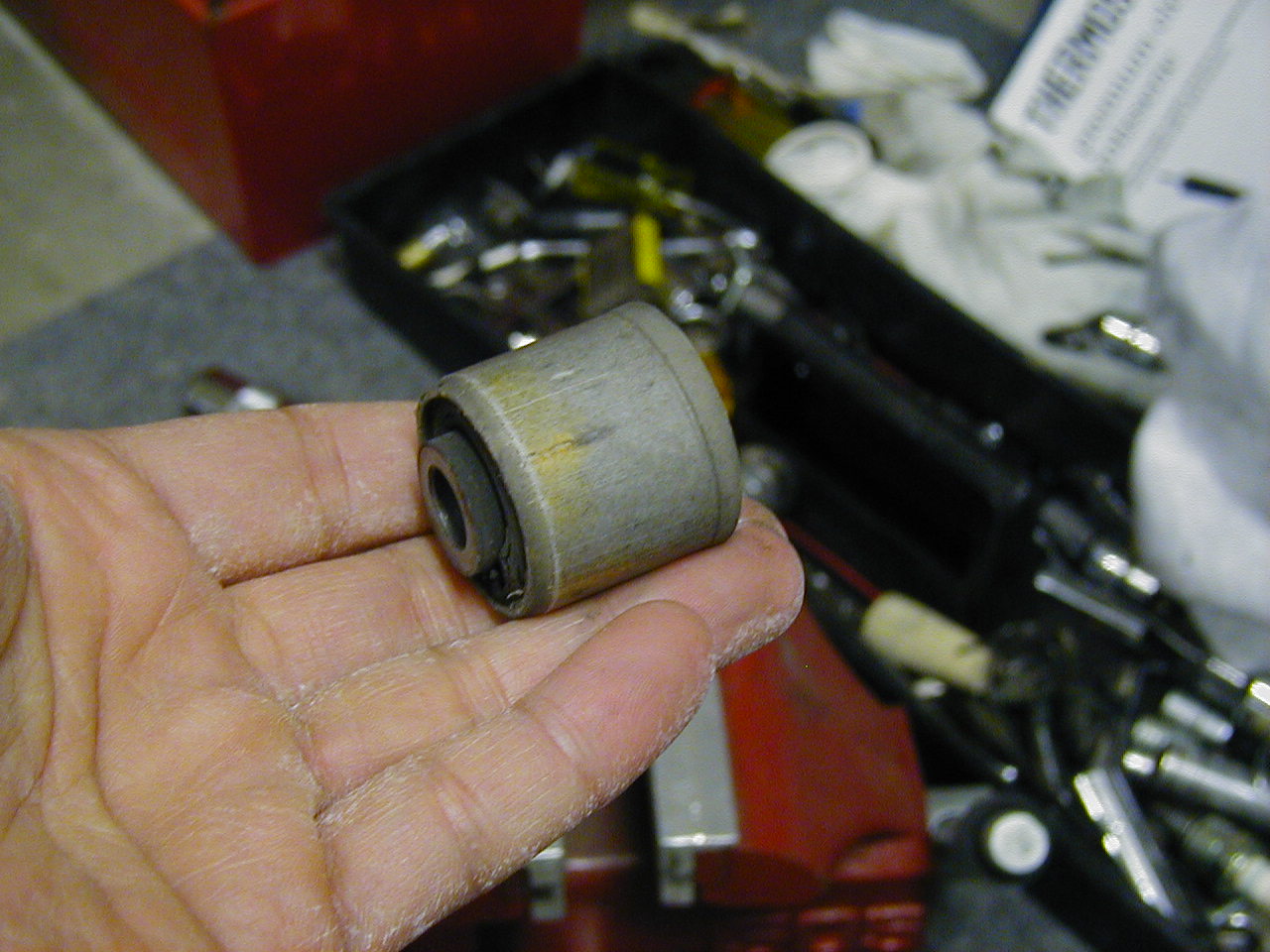 Here's a removed endlink bushing - note the one side has a camfered edge - this is the side you want to hammer it out from.