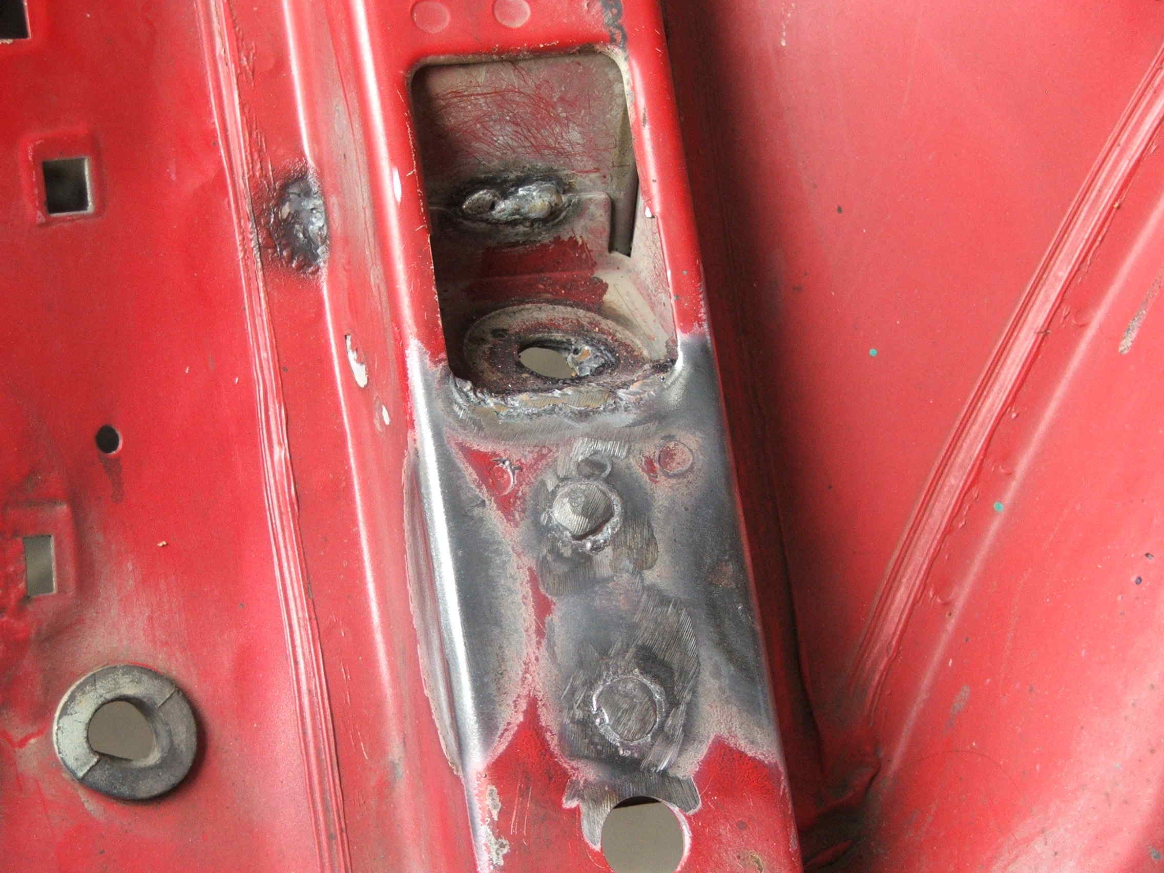 Plug welding plating to shock tower.JPG