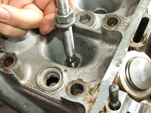3 Pulling bolts inserted into plug hole through plate.JPG
