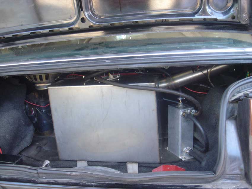 SS Fuel tank in the trunk with surge tank to avoid pressure- drop on the two outer fuel pumps .