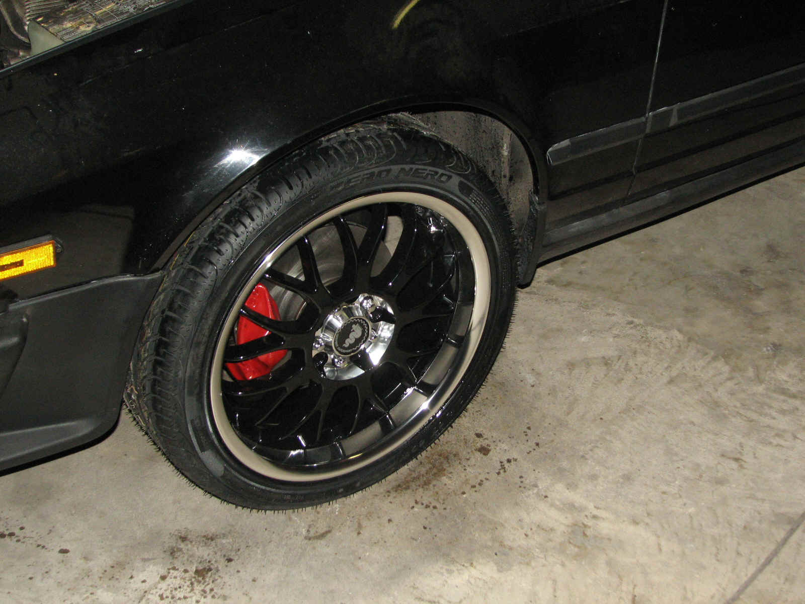 wheel with red caliper (rebuilt brakes, new rotors, steel braided lines)
