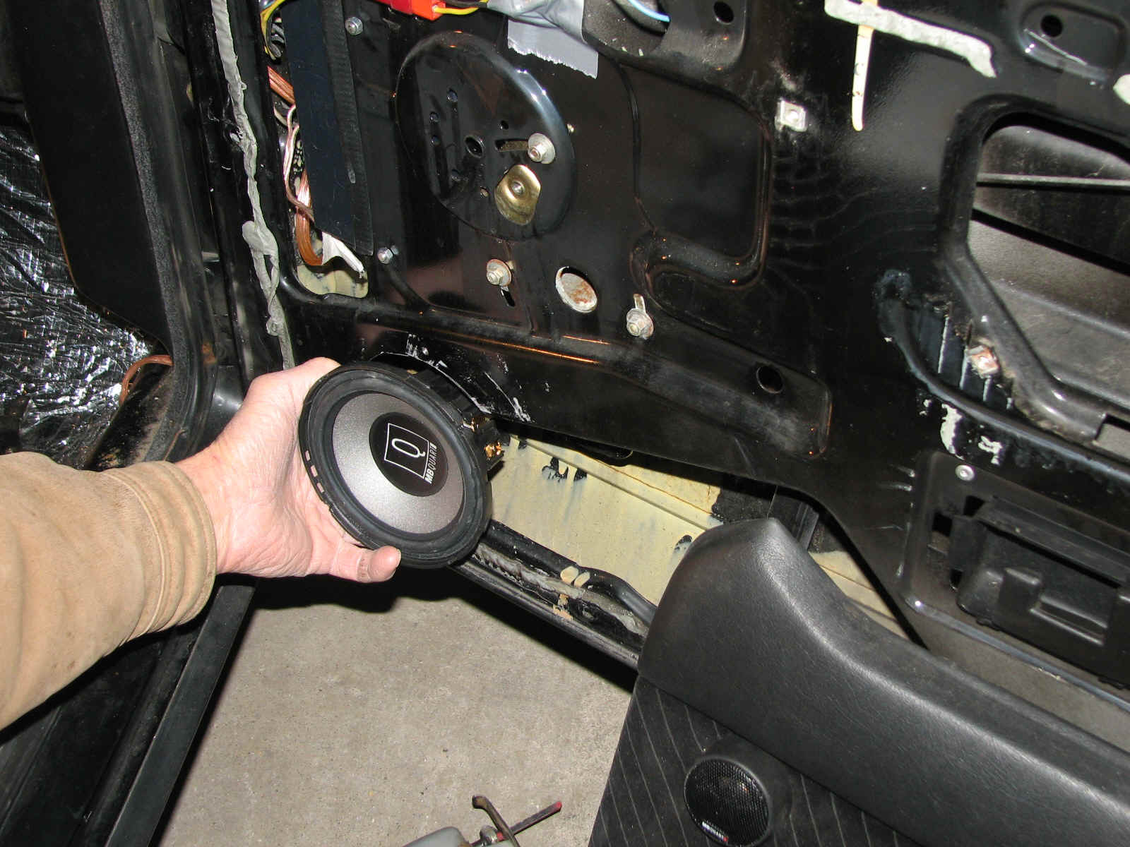 Each door has two speakers, a main speaker, which my dad is holding, and a tiny tweeter mounted above it. These German made speakers appear to be really good. However they are tricky to mount.